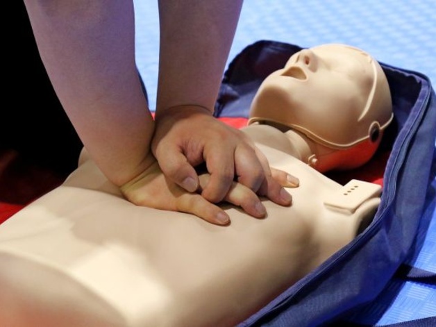 Person performing CPR on a practice dummy